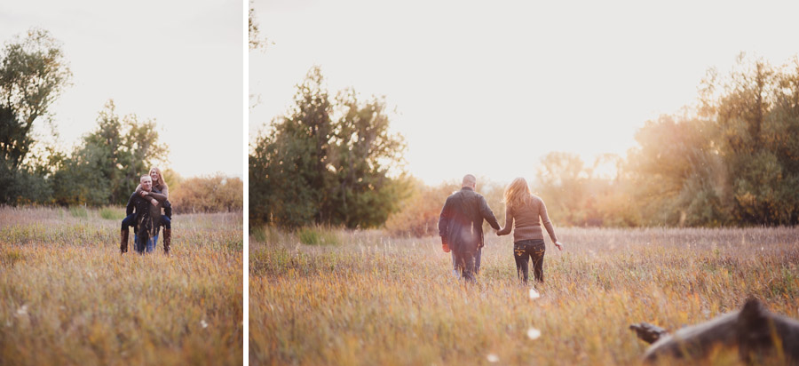 couple walks through golden field during engagement photos