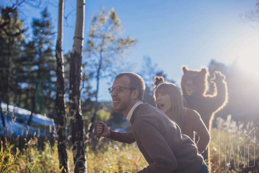 couple running from bear engagement photos