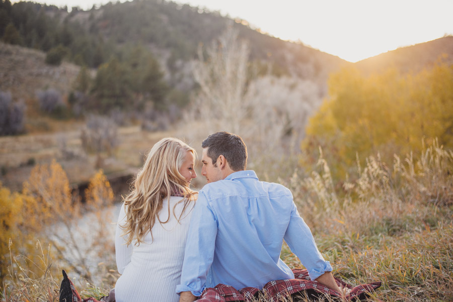 Engaged couple watch the sunset in Evergreen, Colorado