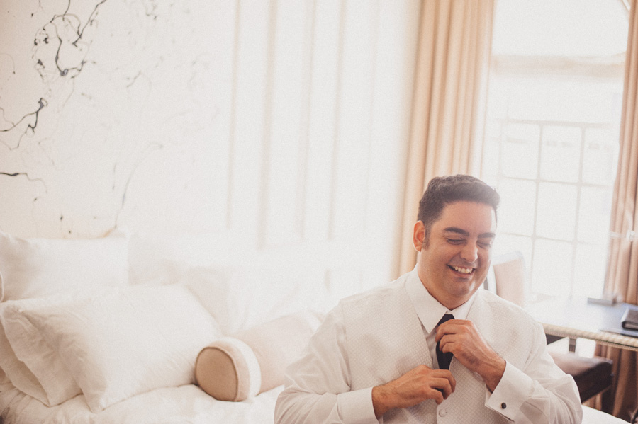 Groom laughing in US Grant Hotel just before balboa park wedding