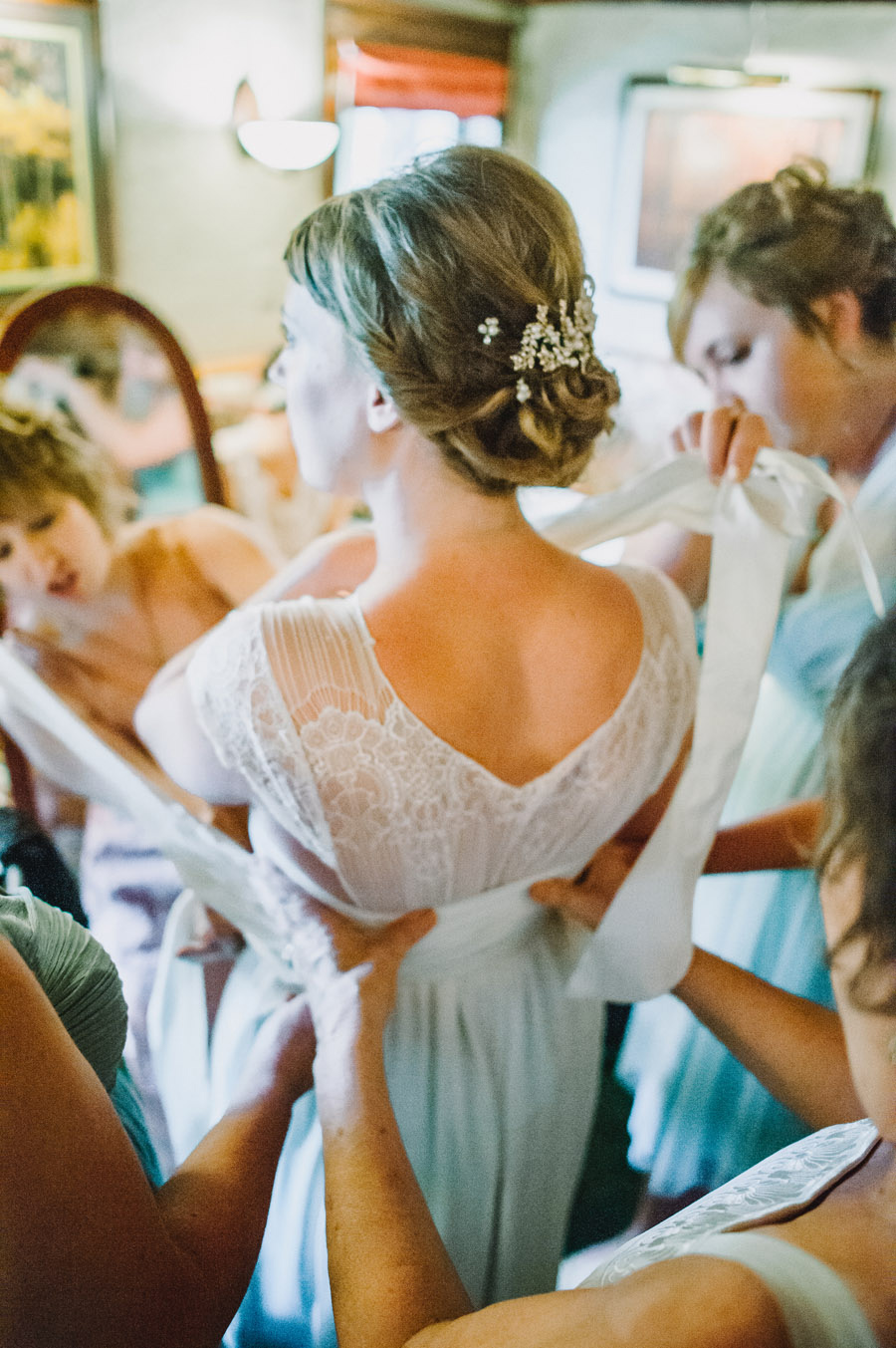 bridal party wrapping bride in vintage wedding dress at the greenbrier in in boulder