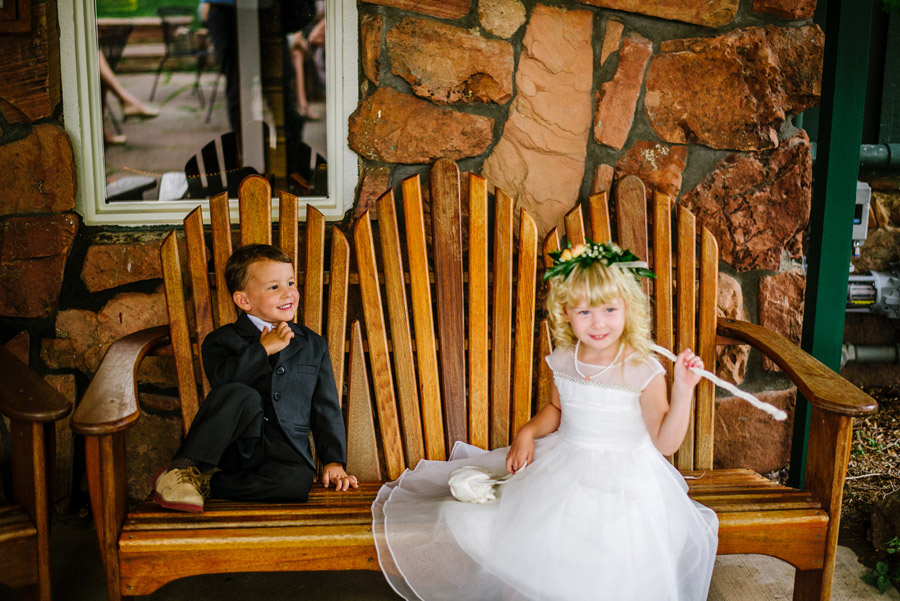 ring bearer and flower girl sharing moment before wedding