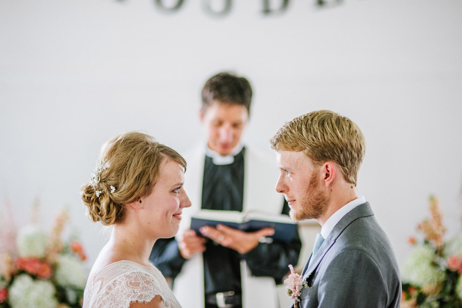 bride and groom lock eyes in ryssby church during wedding
