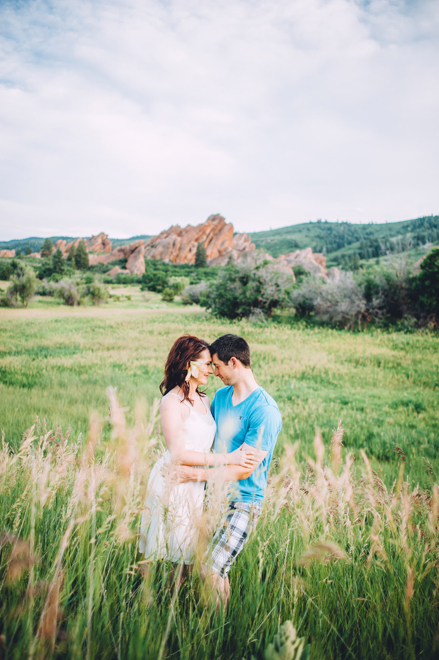 happy couple pose near field in roxborough for third annvierary photos