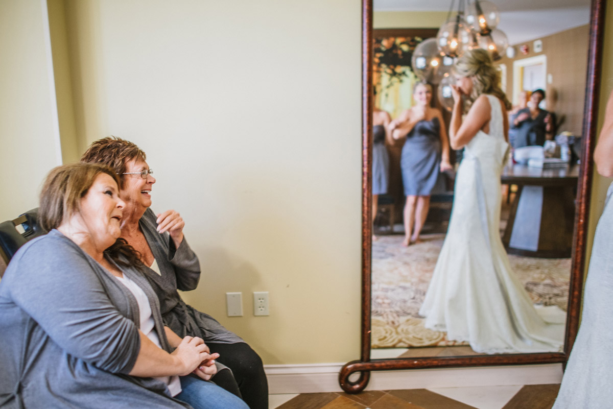 mother of bride crying seeing daughter in wedding dress